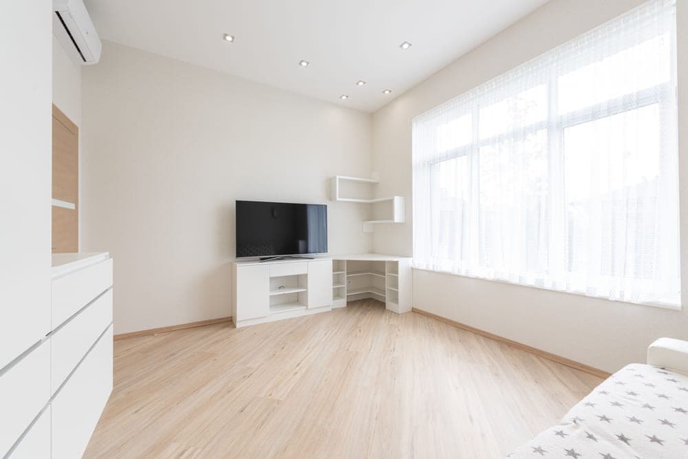 A corner shelf unit in a small room