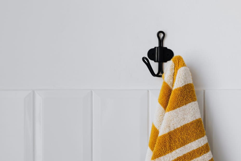 Hooks holding a towel on a plain interior wall