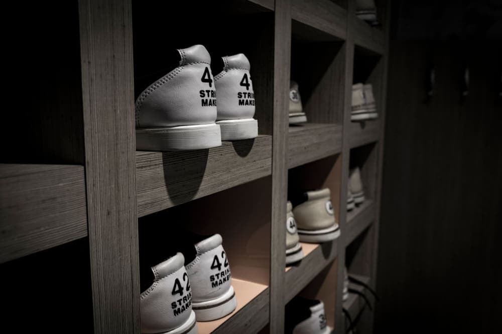 Sneakers organized in rows on shelves in a storage room