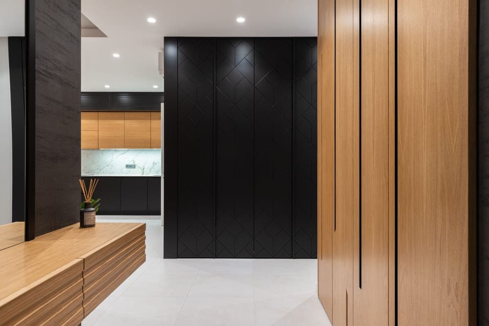 A bright open studio apartment interior with a closet and cabinet