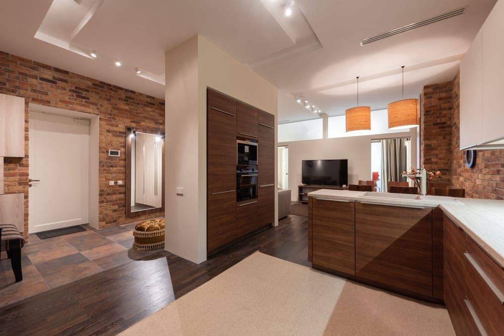 An exposed brick wall inside a loft-style apartment