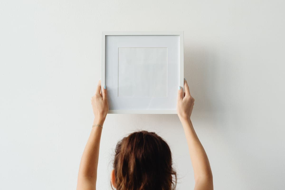 A hook mounted on a plain white interior wall