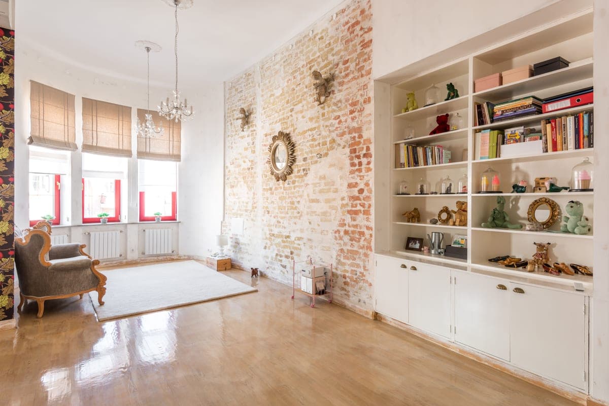 A wall shelf holding books in a small modern apartment